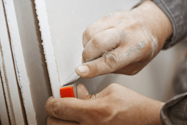 A contractor applying tape to a drywall joint for a smooth, seamless finish.